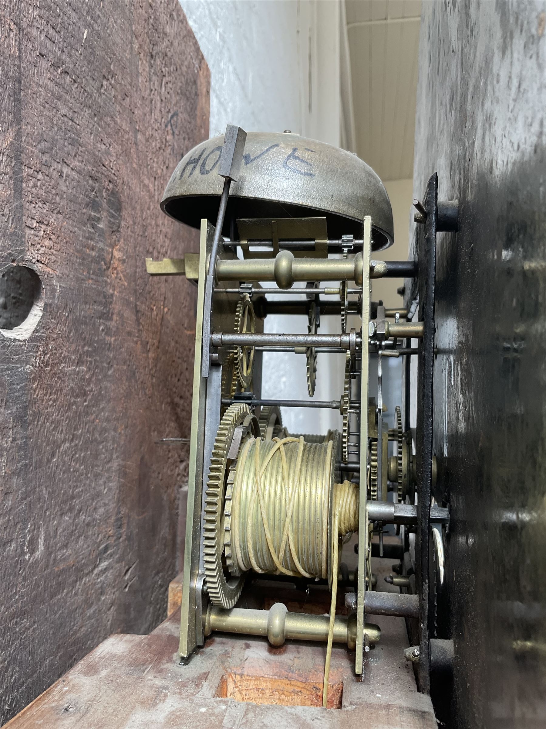 Oak and Mahogany - 8-day longcase clock c1830 with a swan necked pediment and break arch hood door beneath flanked by reeded pilasters with Corinthian capitals,  trunk with three quarter reeded columns and a short door with canted corners, on a conforming plinth with a raised panel, painted dial with Arabic numerals, painted birds to the spandrels and a depiction of a soldier and encampment to the arch, with subsidiary calendar aperture and seconds dial, makers name indistinct, with a rack striking movement striking the hours on a bell.  No weights or pendulum.