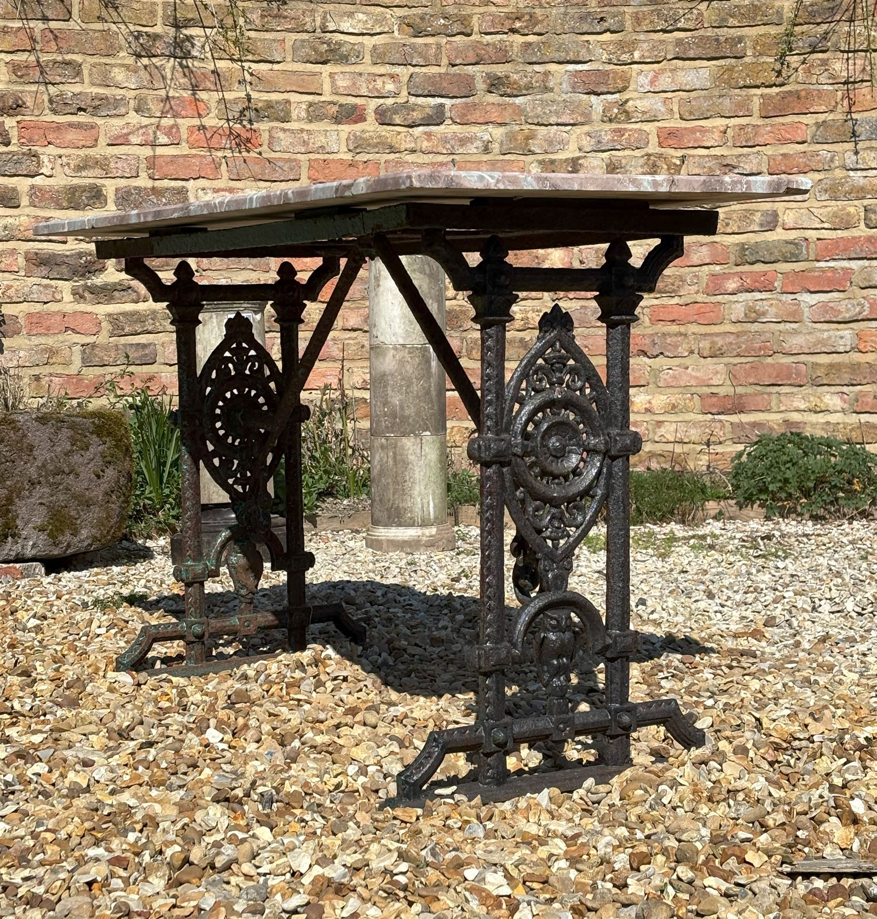 Victorian cast iron garden table, the base with oval cartouches and owl motif supporting an associated variegated rouge marble top. H72cm, L91cm, D46cm.  - COLLECTION BY APPOINTMENT FROM: The White House, Thirsk Road, Easingwold, York, YO61 3NF - CALL 01723 507111 TO ARRANGE