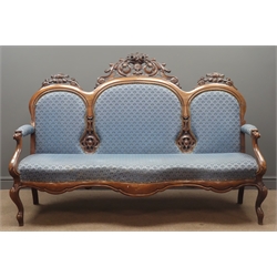  Victorian upholstered walnut sofa, triple arched cresting rail with ornate carved scrolling foliage pediments, shaped apron on cabriole legs, W172cm, D60cm, H120cm  