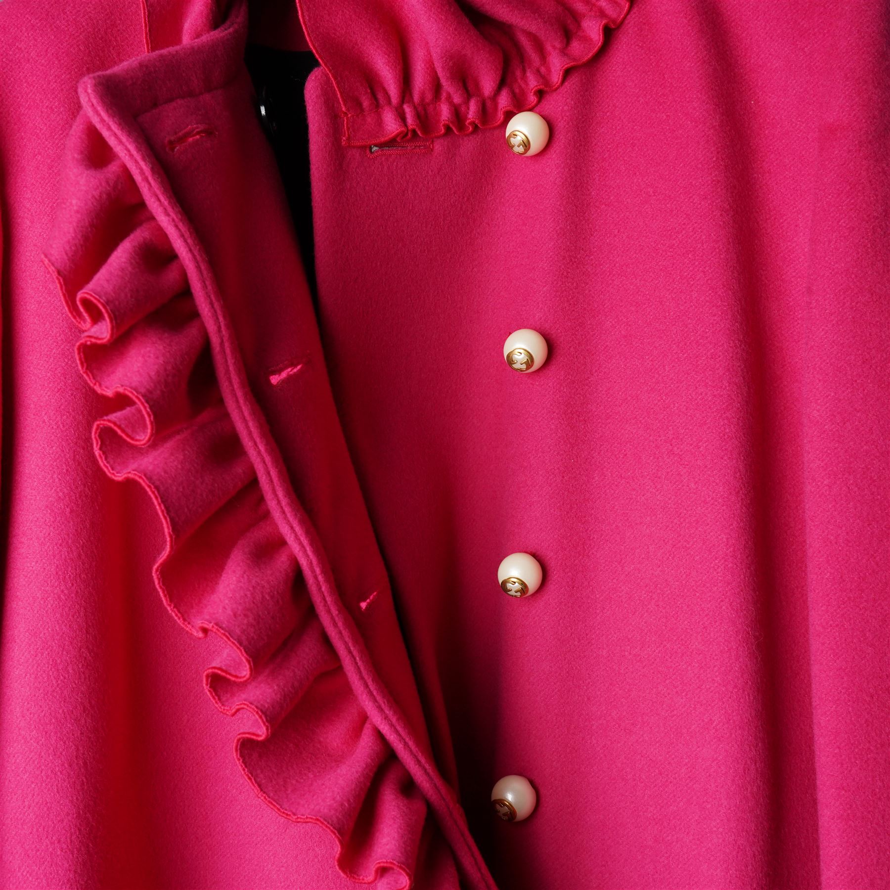 Gucci - wool ruffle-front single-breasted coat in bright fuchsia pink, with high ruffled collar, cascading ruffle trim to the front, collar and cuffs, faux pearl and gilt GG monogram logo button fastening, size 44, unused with the original garment bag and hanger