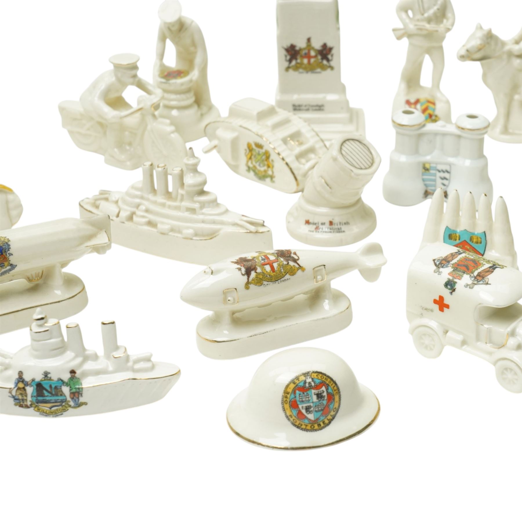 WWI crested china including Arcadian model of British Cavalry Soldier, another 'Tommy in Bayonet Attack', Swan China 'Despatch Rider', Arcadian 'Tommy Atkins', ambulance, E Boat, two tanks, Cenotaph etc