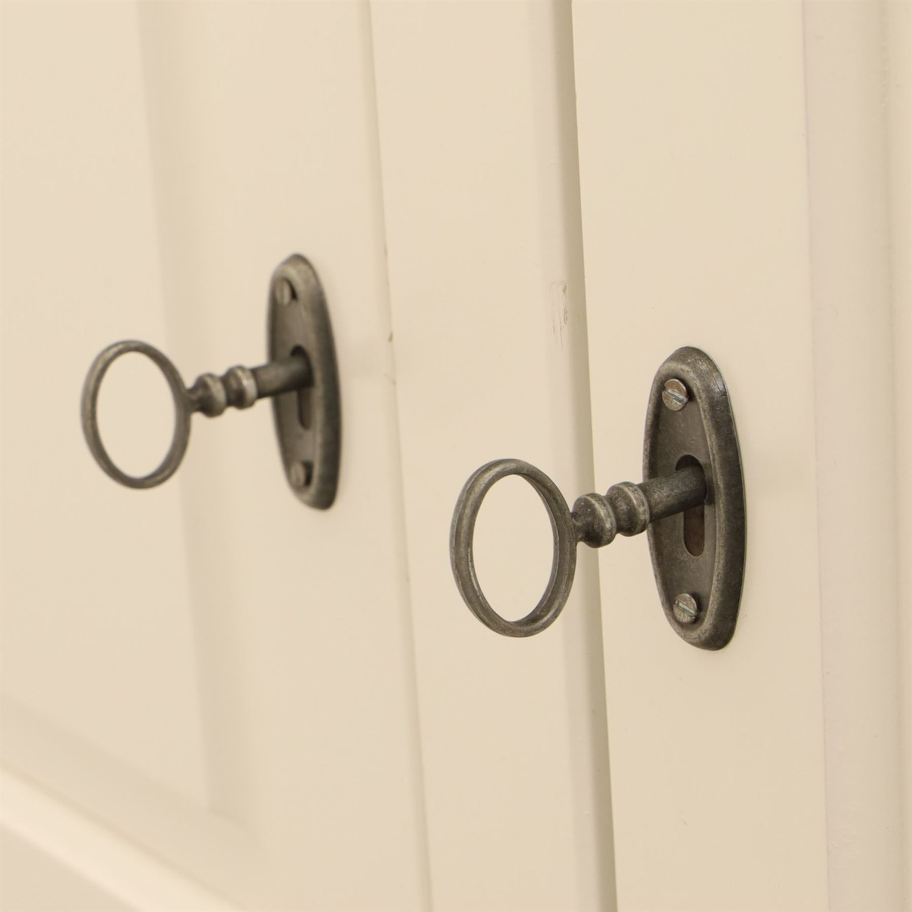 Modern white painted double wardrobe, fitted with two panelled doors, enclosing a hanging rail and shelving, raised on bracket feet