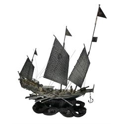 Chinese miniature silver model of a junk ship, with textured sails, mounted upon a carved wooden stand, H14cm