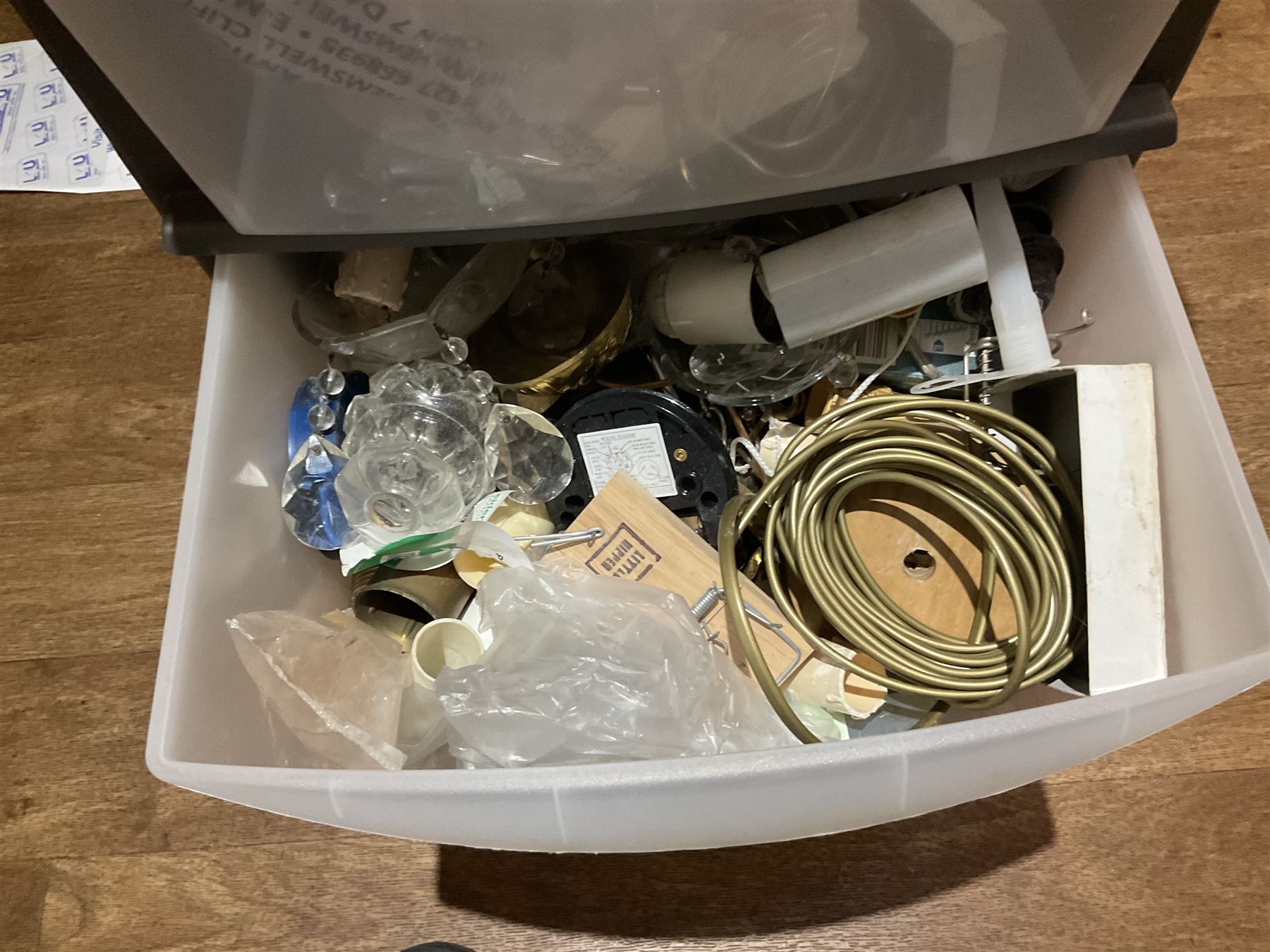 Large quantity of light fitting spare parts and accessories in plastic floor standing six-drawer chest