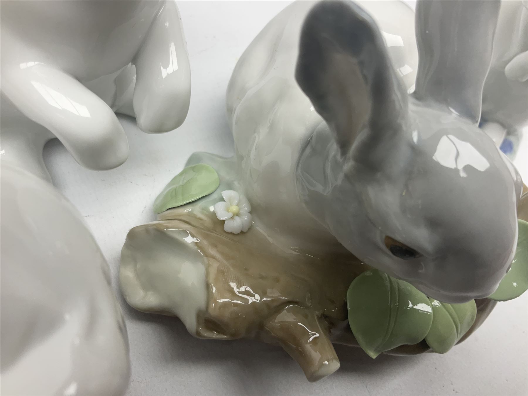 Four Lladro rabbit figures, comprising, Hippity Hop no 5886, Sitting Bunny no 5907, Washing up no 5887, and Rabbit Eating no 4773, largest example 14cm  