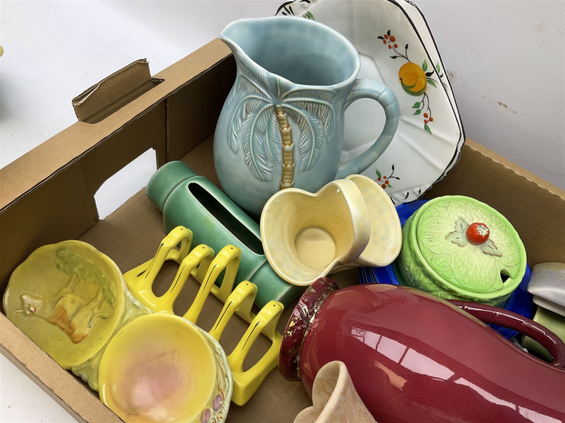 Two Beswick jugs decorated with palm trees, together with matching wall pockets, and similar ceramics, together with six Shelley dishes  