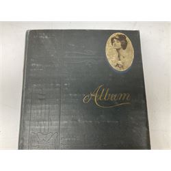 Album containing over two-hundred Edwardian and later postcards including twenty-two WW1 embroidered silks, other WW1 cards, comic, greetings, Bamforth song cards, set of seven Maurice Milliere Theatreuses and other glamour cards, real photographic topographical, groups etc