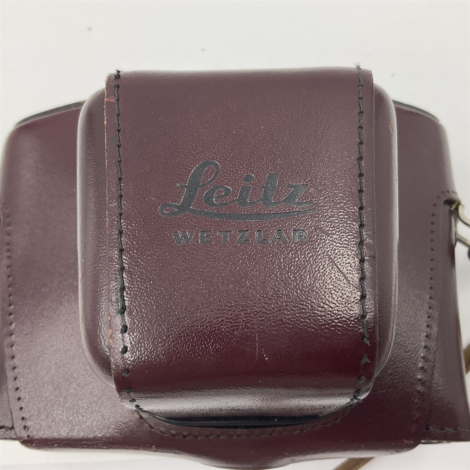 Leitz Leicaflex SL2 camera body, serial no.1387046, with 'Summicron-R 1:2/50 Leitz Wetzlar' lens, serial no. 2273397, within a leather Leitz lens hood 