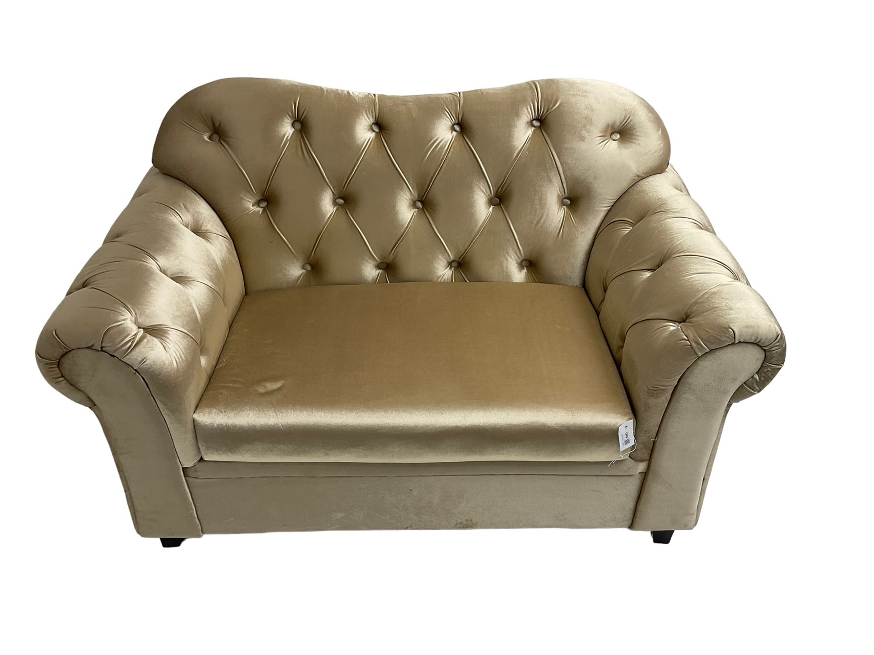 Chesterfield shaped snuggler sofa, upholstered in buttoned champagne fabric, with scatter cushions