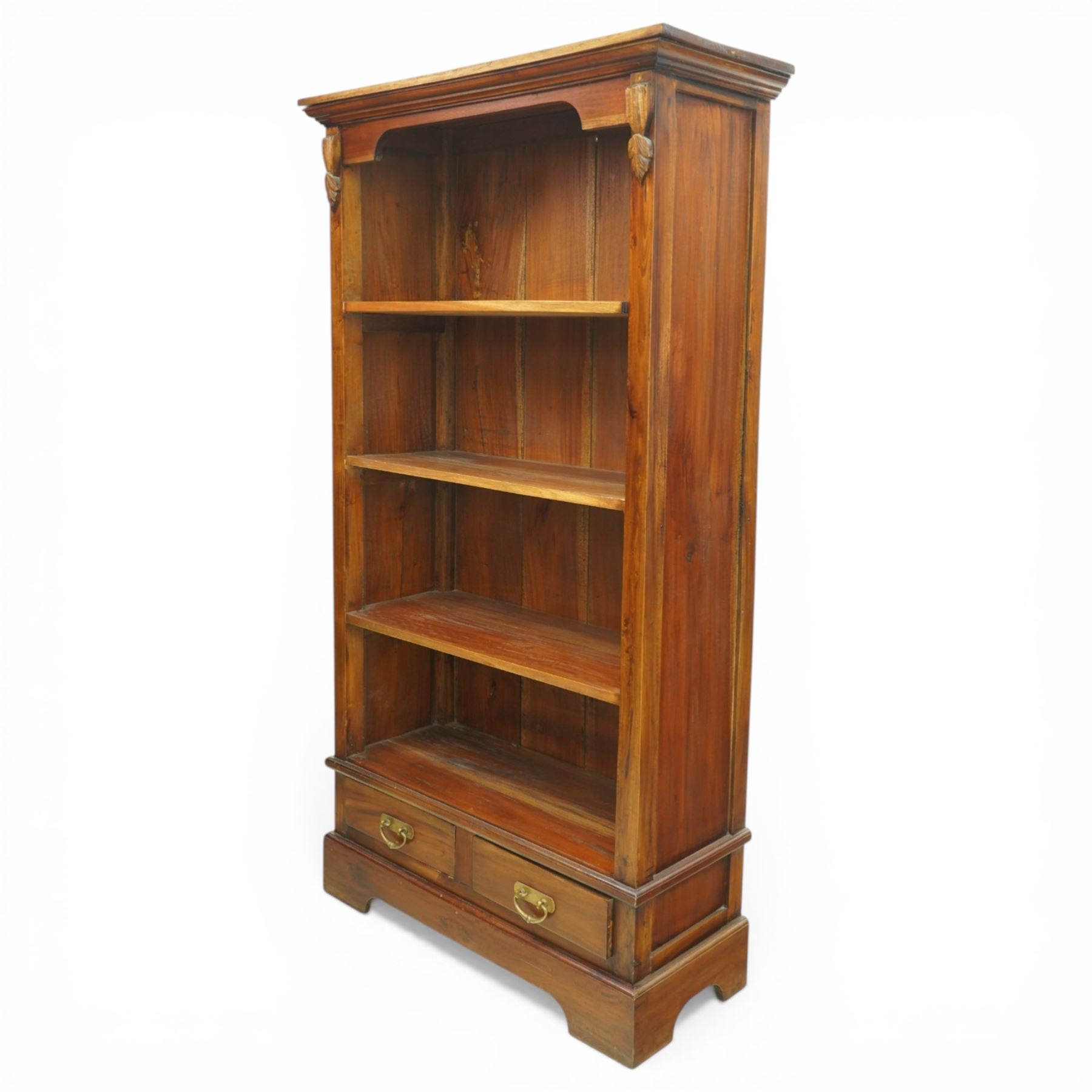 Late 20th century Georgian design hardwood open bookcase, moulded cornice above a shaped frieze, open shelved interior with boarded back, the base fitted with two short drawers with brass swan neck handles, on a shaped plinth