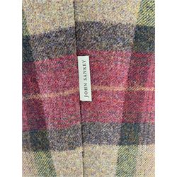 John Sankey - low armchair, buttoned back upholstered in tartan patterned fabric with contrasting grey leather, raised on turned and ebonised front feet with brass and ceramic castors, with matching foot stool