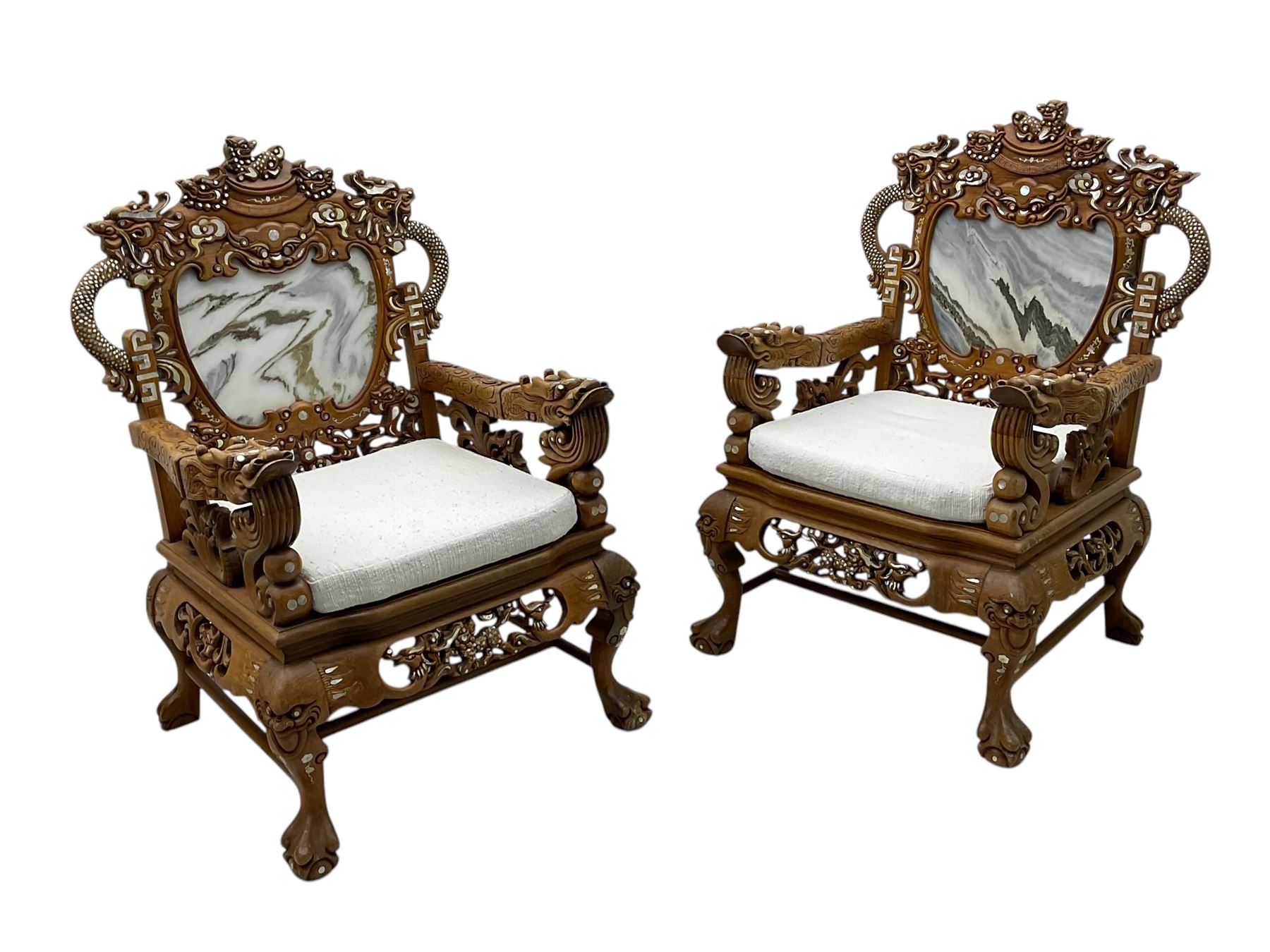 Pair of Chinese hardwood throne chairs, the back with grey marble inset surrounded by carved dragons and masks, inlaid with mother of pearl, the arm terminals carved with dragons, panelled seats inlaid with flowers and foliate motifs, on ball and claw carved cabriole feet