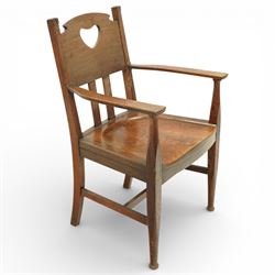 Arts and Crafts oak armchair, the shaped back with heart-shaped pierced splat above three vertical slats, solid dished seat with rounded front, open arms on turned front supports, square section legs united by plain stretchers