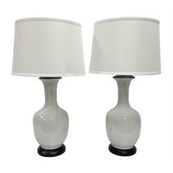 Pair of Chinese white crackle glazed table lamps, each of bottle form, raised upon circular hardwood bases, including shade H72cm