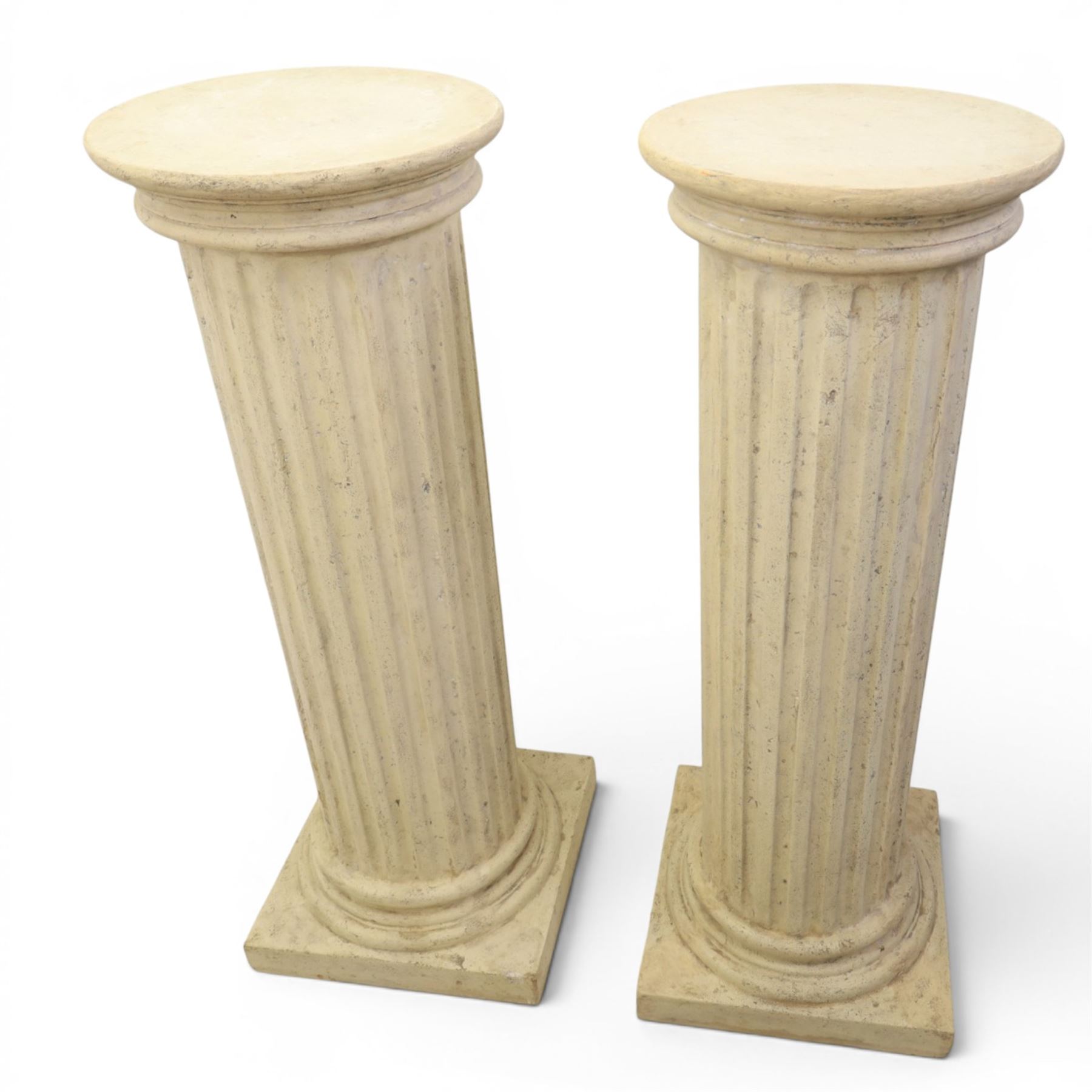 Pair of Regency style composite stone column pedestals, with fluted cylindrical columns and moulded capitals and bases, on square plinths