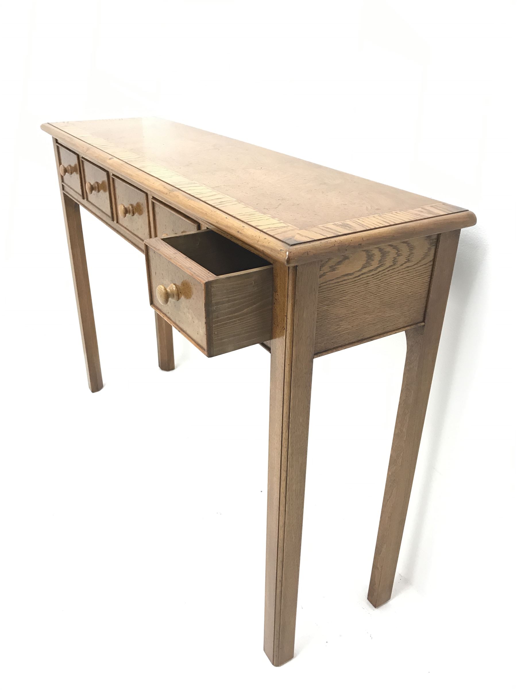 Contemporary oak, mahogany, and figured burr walnut narrow console table, moulded rectangular top with oak band and satinwood stringing, five cock beeded short drawers with turned handles, moulded and canted square supports 
