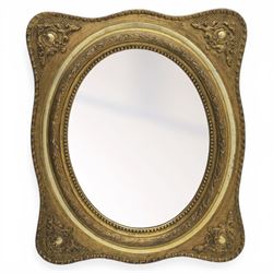 Early 20th century giltwood mirror, oval mirror plate, surrounded by egg and dart moulding, with foliate motifs
