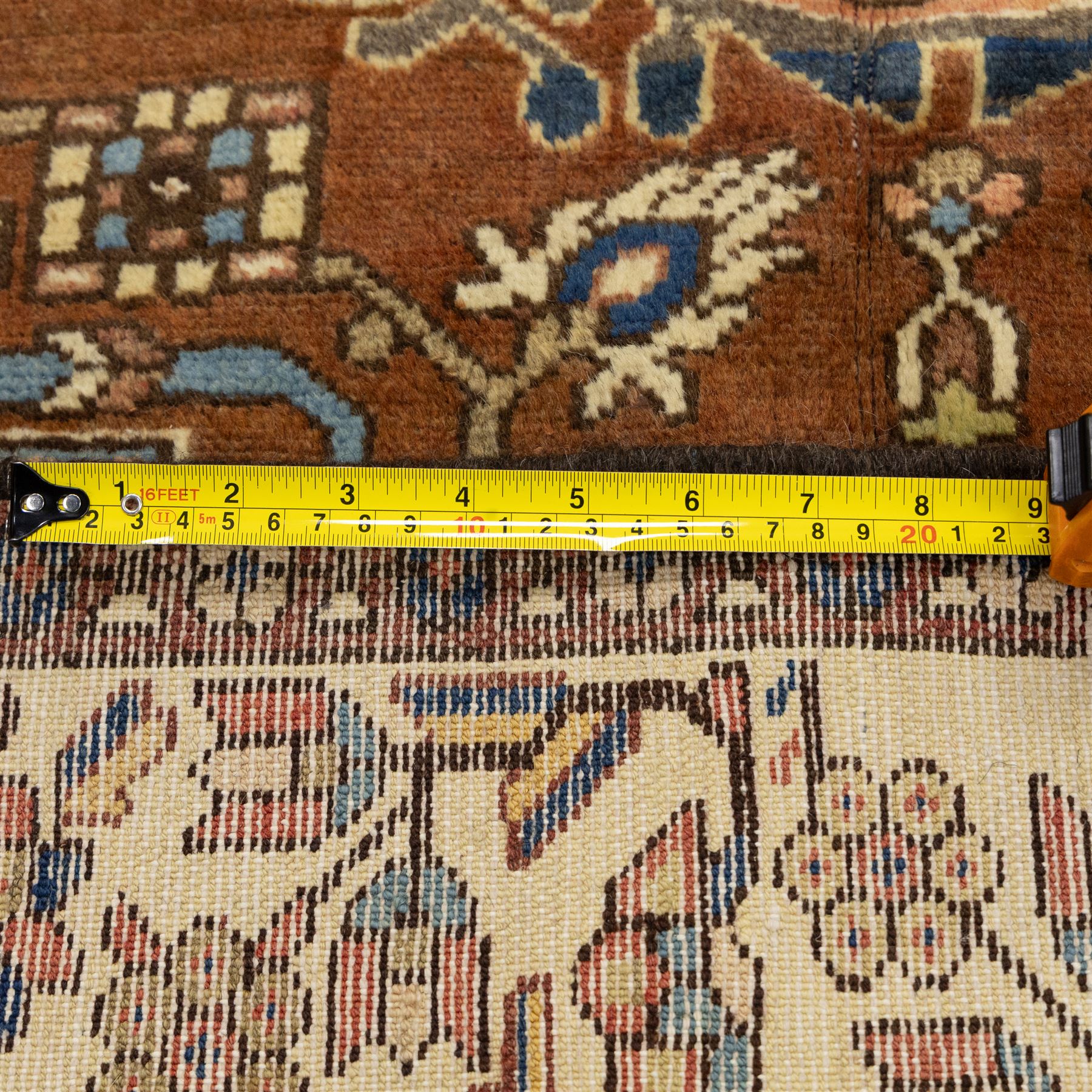 North West Persian Tafresh hand-knotted rug, pale apricot field with central stepped medallion enclosing stylized floral and angular motifs framed by indigo spandrels and multiple stylized floral borders, cotton fringe ends 
