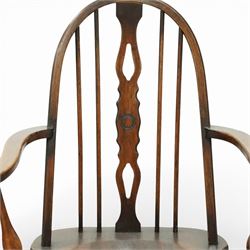 Early 20th century Windsor armchair, the arched hoop back enclosing a pierced and shaped splat flanked by turned spindles, above a shaped elm seat and outswept arms on turned supports, raised on turned legs united by an H stretcher