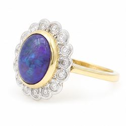 18ct gold black opal diamond cluster ring, single oval cabochon cut opal of 2.76 carat, surrounded by fourteen round brilliant cut diamonds, London 1998, total diamond weight 0.60 carat