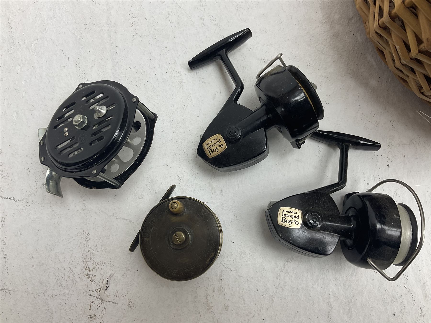 Fishing tackle and accessories housed in two wicker creels, including a landing net, fly tin, small brass reel, other reels to include two Intrepid Boy'o examples, crab lines etc 