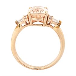 14ct rose gold pink / peach sapphire and diamond ring, single oval cut sapphire of 3.07 carat, with two round brilliant cut diamonds and a pear cut diamond set either side, stamped, total diamond weight 0.11 carat, with Gem Lab report