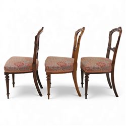 Set of six late Victorian mahogany dining chairs, the shaped top rails carved with anthemion motifs, above pierced splats, floral and geometric fabric seat, on turned and fluted front legs