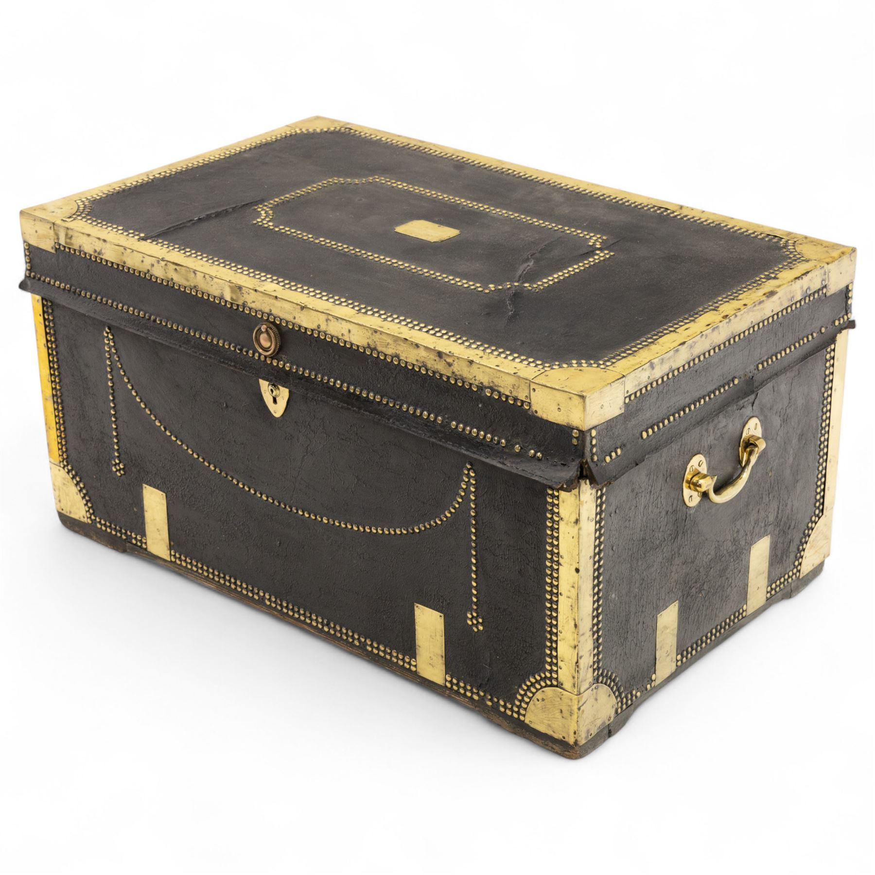 An early 19th-century Georgian brass-bound travelling trunk, leather-covered exterior with brass stud work decoration, front with central brass lock plate, hinged lid with camphor wood interior, external sides fitted with large brass carrying handles 