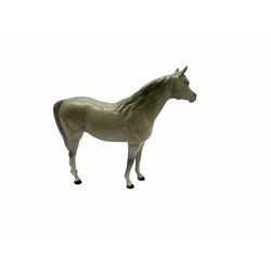 Beswick horse figures, comprising Highland Pony 1644, and another, probably Aran Bahram in grey, each with printed mark beneath.
