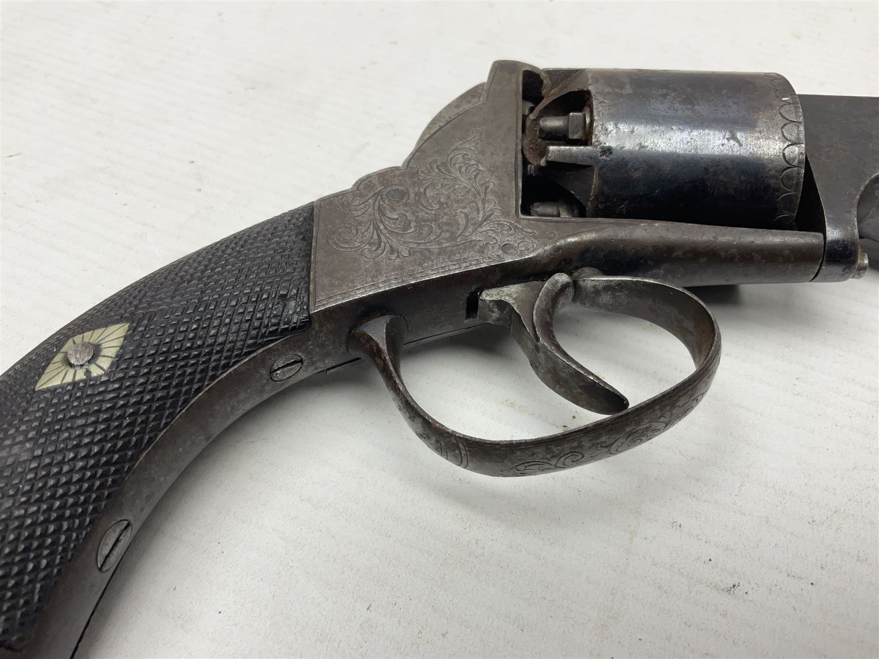 Mid-19th century Smith London .36 cal. transitional five-shot percussion revolver, the 12cm rifled octagonal barrel with side loading lever, side safety, some engraved decoration and chequered two-piece grip L28cm overall
