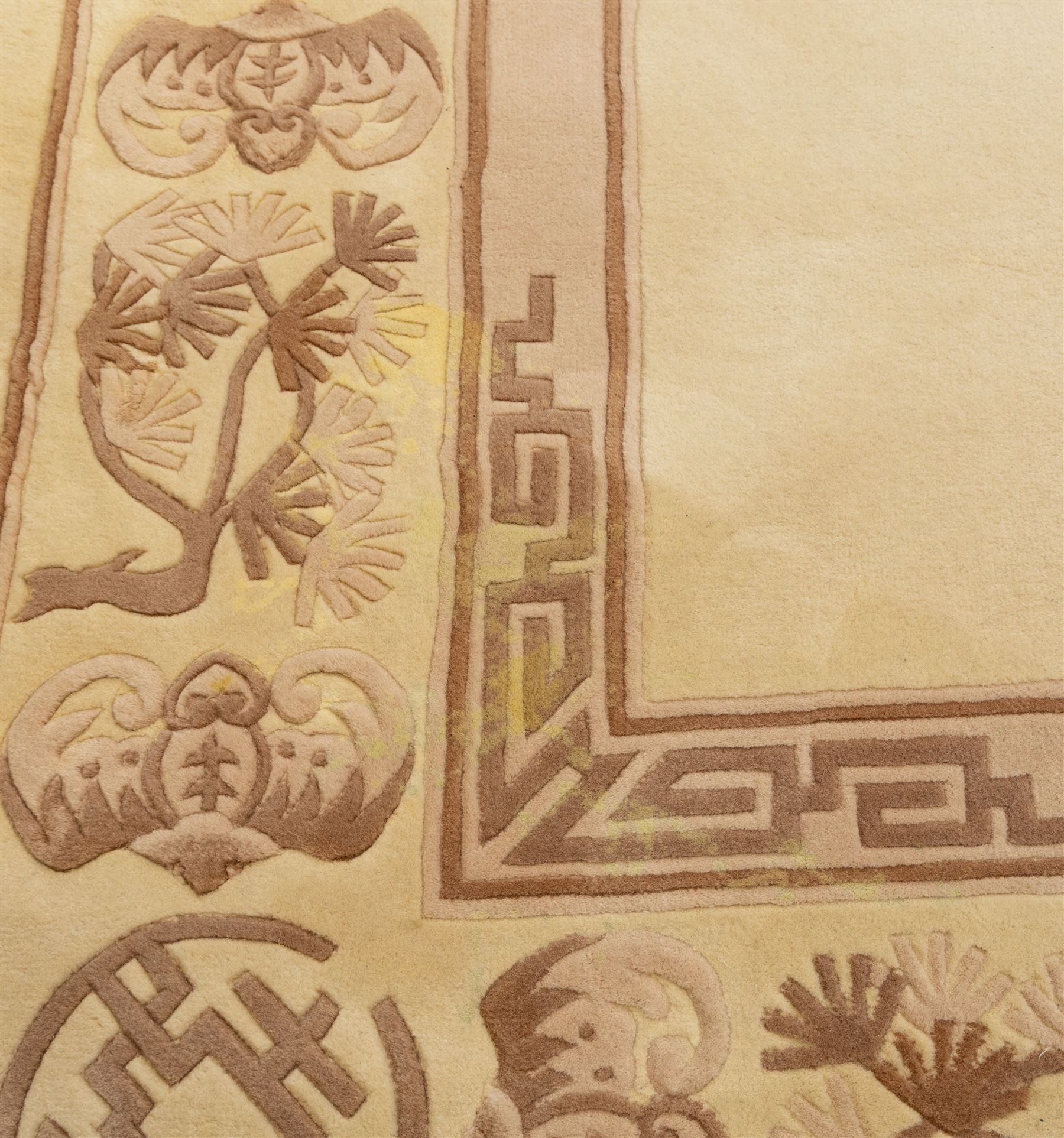 Late 20th century Chinese wool carpet, cream field with five stylized dragons arranged in a circular formation around a central flaming pearl motif, dragons depicted with elongated bodies and clawed feet amongst stylized cloud forms, enclosed within a narrow inner border and a wider outer border decorated with traditional Chinese motifs and symbols