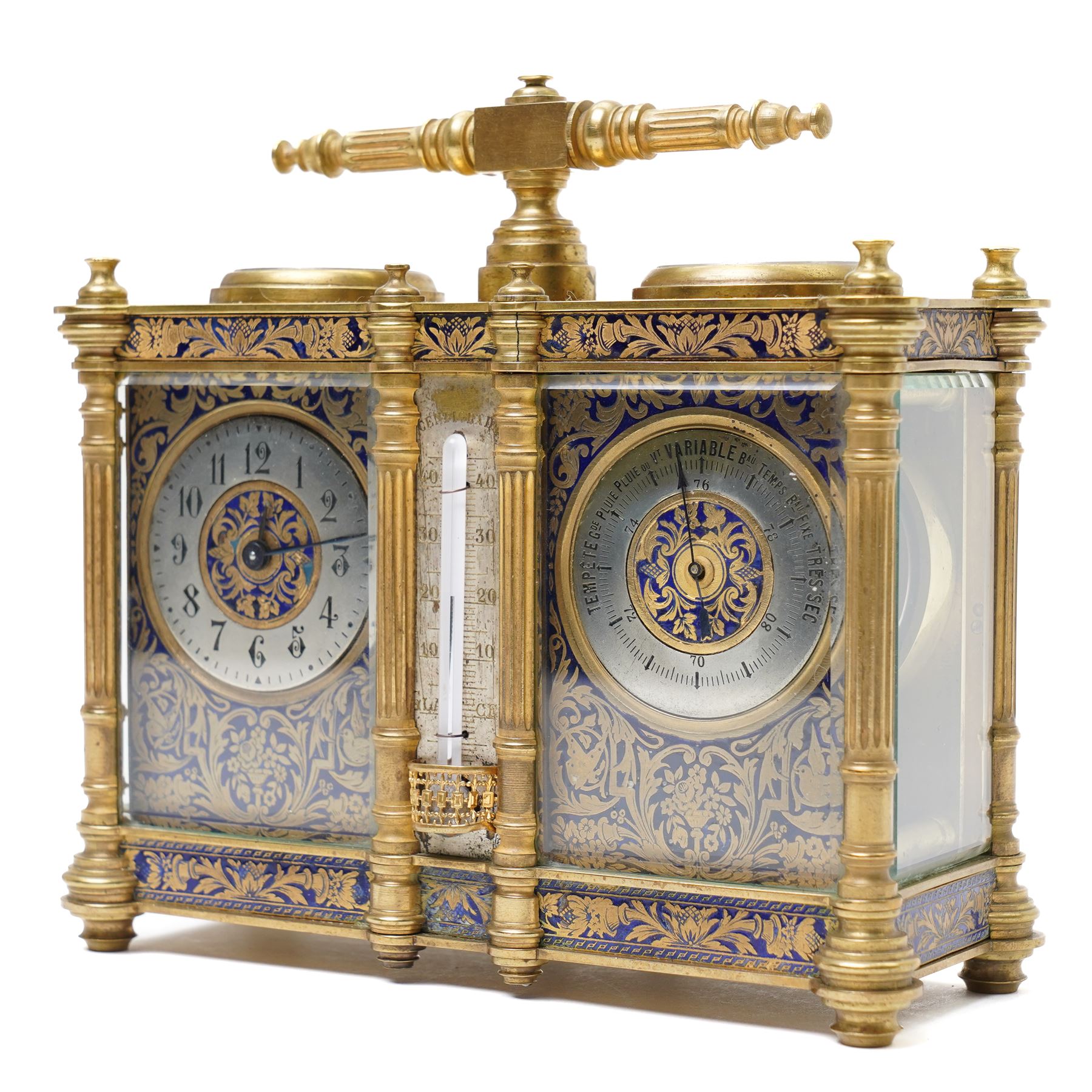 French-late 19th century combination brass carriage timepiece with barometer, thermometer and compass, with a fluted T bar handle and eight matching columns with turned finials, bands of fretted brass to the base and cornice and conforming decoration to the dial masks and dial centres, with silvered chapters to the time dial and barometer and a mercury thermometer between, the top with a circular bevelled viewing glass to the escapement and compass to the other, with a single train 8-day movement and cylinder platform escapement.  With key.