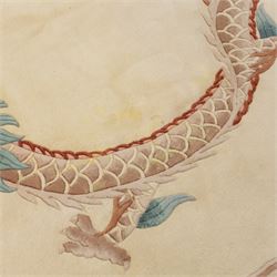 Late 20th century Chinese wool carpet, cream field with five stylized dragons arranged in a circular formation around a central flaming pearl motif, dragons depicted with elongated bodies and clawed feet amongst stylized cloud forms, enclosed within a narrow inner border and a wider outer border decorated with traditional Chinese motifs and symbols