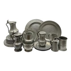 Collection of 18th and 19th century pewter, comprising two chargers, eight large plates, twenty six smaller plates, two bowls, three lidded measures, two jugs, tappit hen, and tankard, the plates with various marks and touch marks, including pseudo 'hallmarks', largest charger 37cm, large plates D30cm, smaller plates D24.5cm, tappit hen H26.5cm