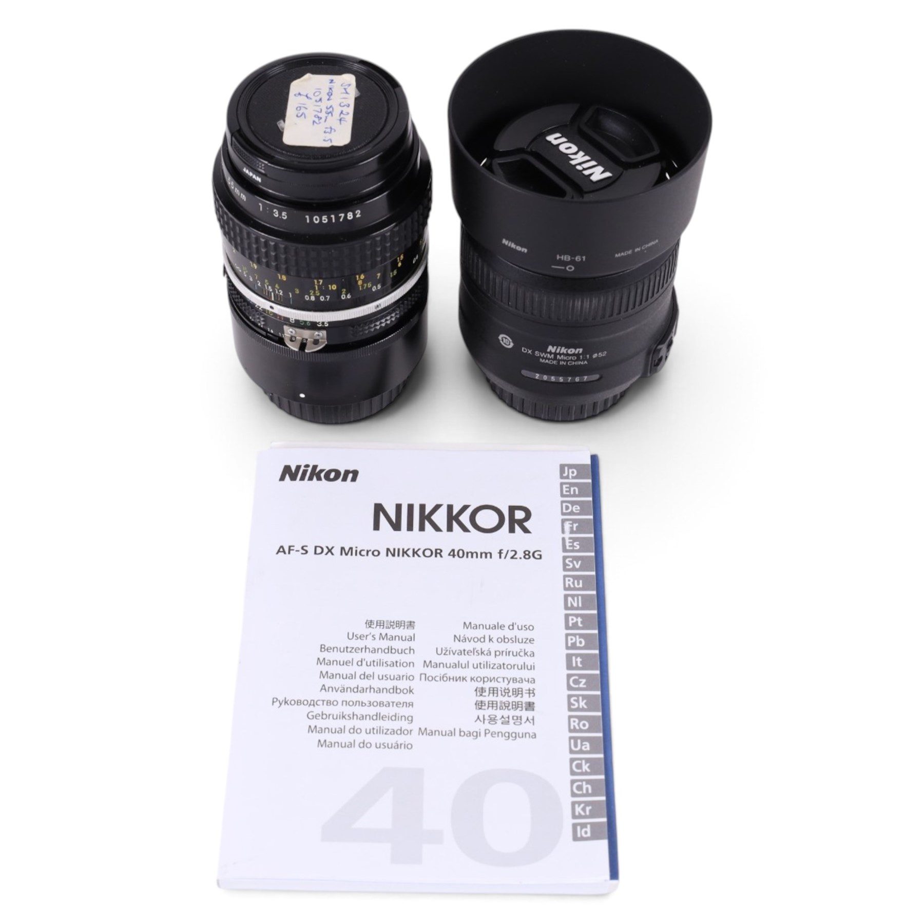Two Micro-Nikkor camera lenses, comprising AF-S DX 40mm 1:2.8G with user manual, serial no. 2055767 and a 55mm 1:3.5 serial no. 1051782