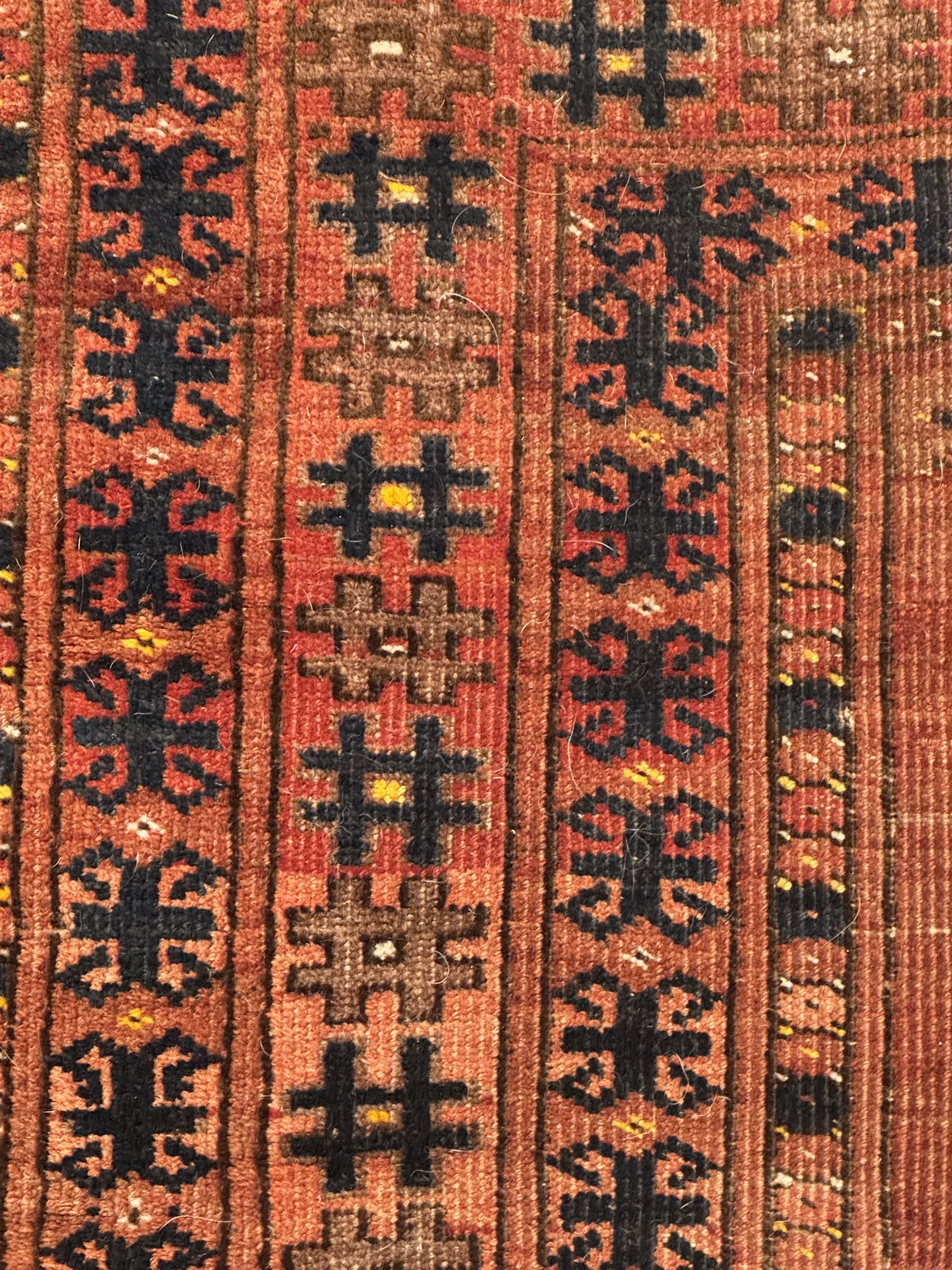 Turkish Kilim ground rug, the field with alternating horizontal bands of geometric patterns, bordered by repeating diamond motifs (145cm x 242cm); Turkish red ground rug, the field with three octagonal medallions (113cm x 172cm) (2)