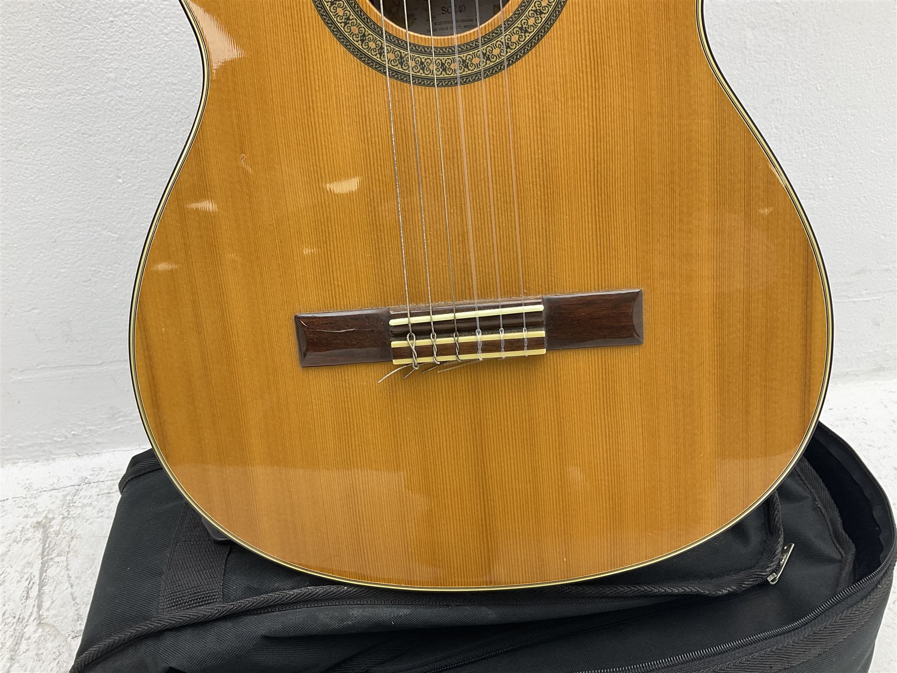 Nagoya Suzuki Model SC240 acoustic guitar with mahogany back and ribs and spruce top, bears label, L101cm; in soft carrying case