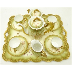  Early 20th Century cabaret set comprising, oblong two handle tray, teapot, sucrier, cream jug and four cups and saucers, each with floral and gilt decoration  