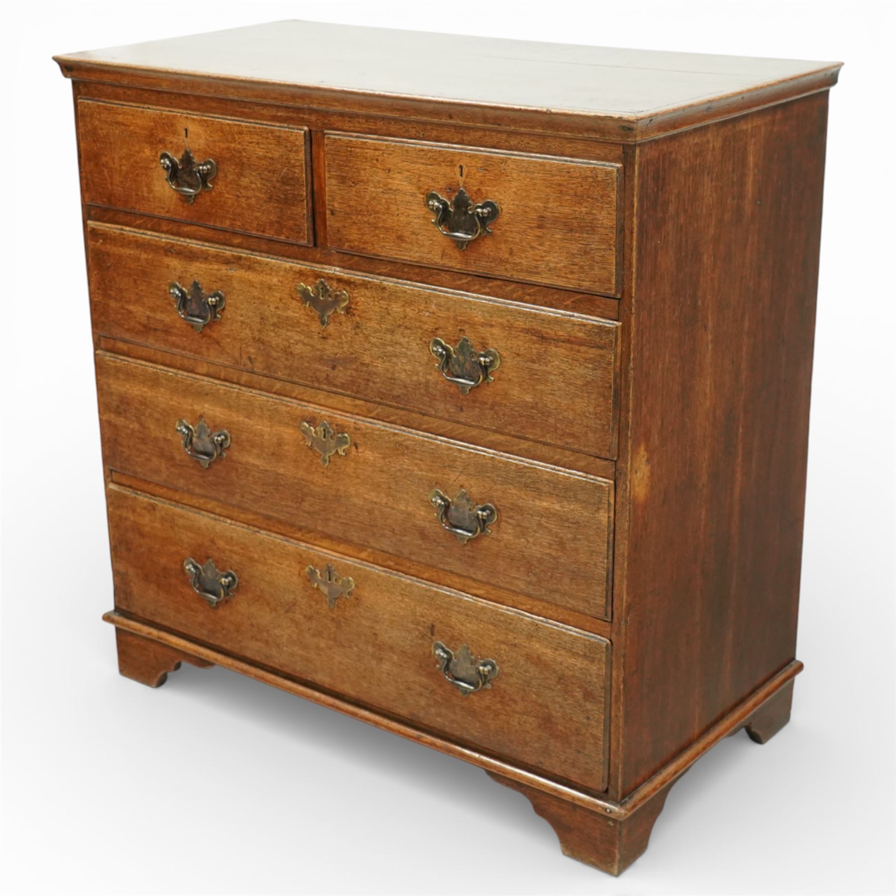 George III oak chest of drawers, the plain moulded top above a two over three drawer arrangement with pierced brass fittings, the case raised on bracket feet