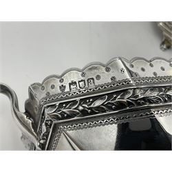 Victorian silver four piece tea service, comprising teapot, teapot stand, twin handled open sucrier and milk jug, each of octagonal form with foliate bud border and engraved decoration including crest to canted panels, and vacant panels, the teapot with ivory finial to the hinged cover and later wooden handle, hallmarked Edward Barnard & Sons Ltd, London1896, teapot including finial H15cm, milk jug including handle H16cm, teapot stand W11.5cm

This item has been registered for sale under Section 10 of the APHA Ivory Act