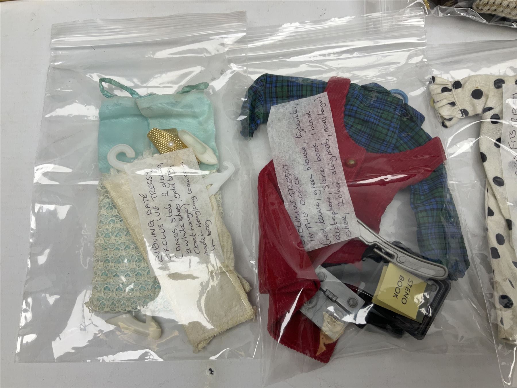 1960s Palitoy Tressy fashion doll, boxed with stand and booklets; four additional Tressy outfits (In The Office, Winter Journey, Winter Sports and Evening Date); two other outfits; and Tressy's Little Sister Toots doll with Style Book and additional outfit