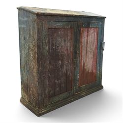 19th century painted and lacquered pine clerks desk bureau on cupboard, hinged fall-front enclosing three compartments, over slatted panelled doors enclosing two perforated shelves, on skirted base, in rustic forest green and red finish