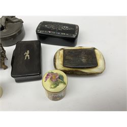 Group of 19th century and later snuff and other boxes, to include black papier mache example with mother of pearl decoration to the hinged cover, horn example with naïve inset decoration of a figure, turned treen example, tack box with cover surmounted with figure, Continental porcelain box and cover decorated in the manner of Helena Wolfsen with spurious beehive mark beneath, etc. 