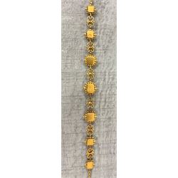 19th century gold emerald necklace, seven closed back octagonal cut and square cut emeralds, surrounded by a fancy bead setting, each spaced by a pierced scroll and bead design link, to a cable link chain necklace, with The Gem & Pearl Laboratory report