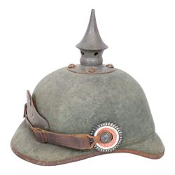 WWI Prussian 22nd regiment Ersatz Felt Pickelhaube, the grey felt skull with steel spike finial, 22 helmet plate and leather chin strap, one side with a black cockade, the other black and red,  the inner back brim stencilled BA 1X Wm Kleddinghaus & C, Elberfeld, 1916, H24cm