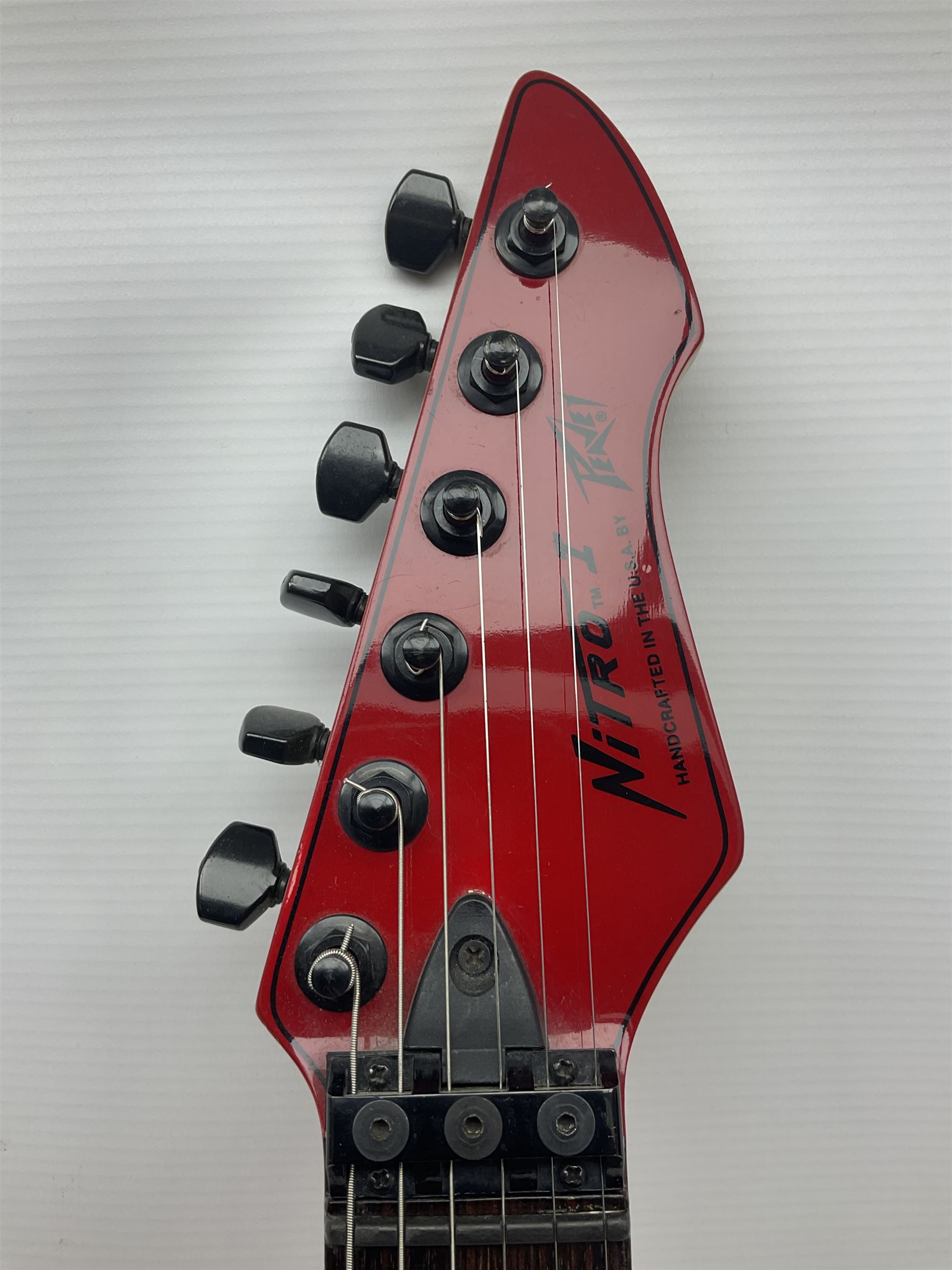 American Peavey Nitro 1 hand-made electric guitar in red with Kahler tremolo, serial no.02786479, L98cm overall; in soft carrying case.