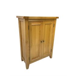 Solid light oak cupboard, fitted with two panelled doors enclosing two shelves, on tapered feet