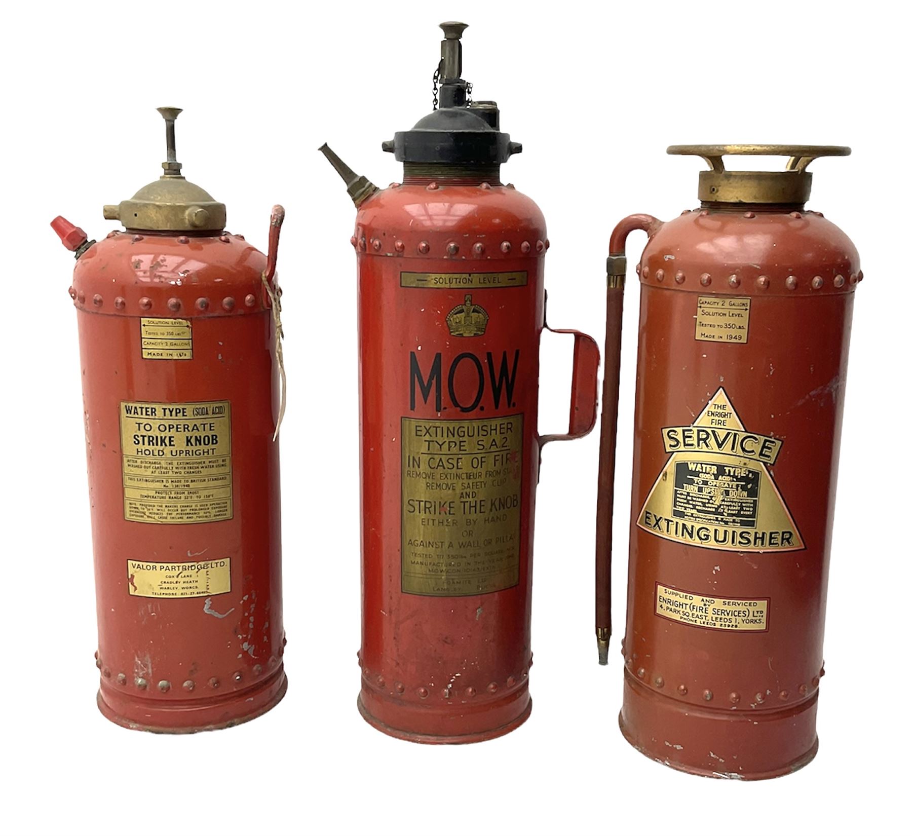 Three fire extinguishers to include an Enright Fire Services extinguisher dated 1949, a Valor Partridge Ltd. example dated 1970 and a M.O.W. example, tallest H63cm