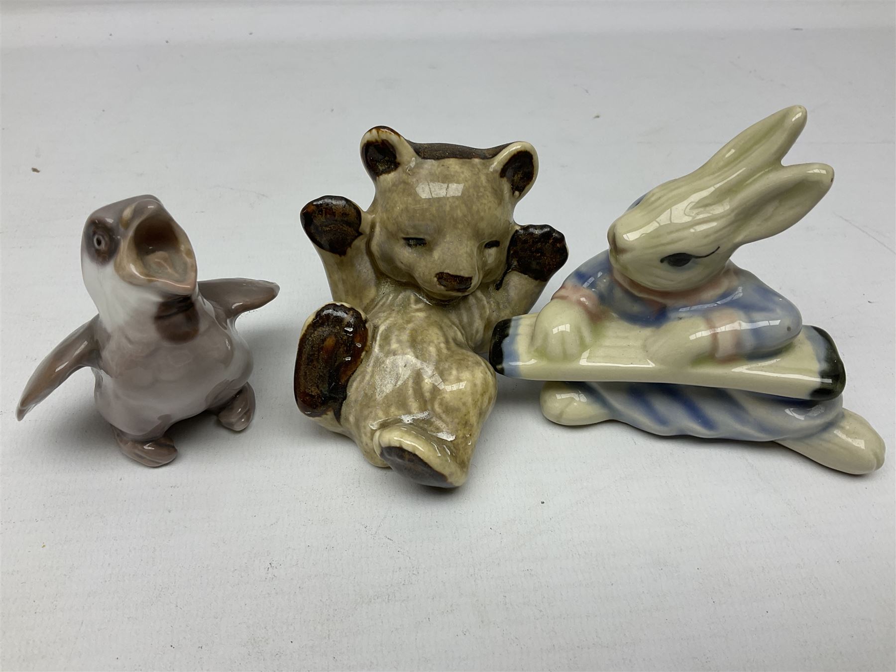 Three Beswick figures of horses, comprising Palomino foal 915, Dapple Grey foal and bay, together with Bing & Grondahl 1852 fledging sparrow modelled as a hungry baby bird and two other animal figures