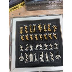 Star Trek Paramount Pictures Official Chess Set, incluidng glass board with removable lid, opening to reveal full set of gold and silver plated pewter figural chess pieces, with certificates, together with a Star Trek USS Enterprise Telephone, Star Trek Monopoly, 30th Anniversary DVD box set, Star Trek novels, DVDs, CDs, etc